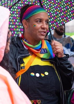 A U N E student wearing a rainbow headband and bandana at a Portland Pride Parade